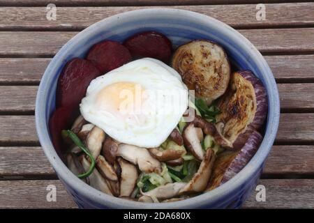bowl with mushrooms eggplant zucchini beet and boiled egg as vegan diet food Stock Photo