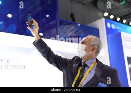 Shanghai, China. 6th Nov, 2020. A German exhibitor takes a selfie during the third China International Import Expo (CIIE) in Shanghai, east China, Nov. 6, 2020. The expo is scheduled to run till Nov. 10. Staff members, exhibitors and visitors take photos to keep precious moments of the event. Credit: Lu Ye/Xinhua/Alamy Live News Stock Photo