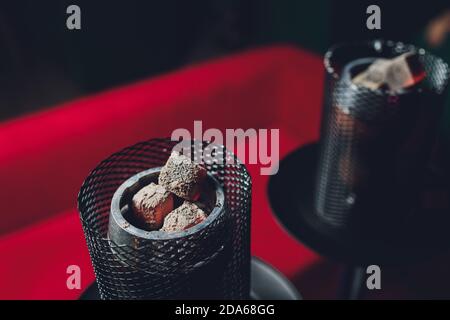 Shisha hookah with red hot coals. Sparks from breathe. Modern hookah with coconut charcoal and shisha smoke. Hookah and sparks from coals.,traditional Stock Photo