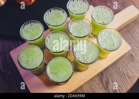 Variation of hard alcoholic shots served on bar counter. Blur bottles on background. Stock Photo