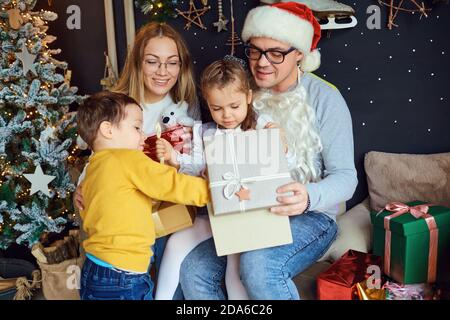 Happy family opening Christmas gifts Stock Photo