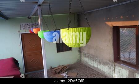 02 November 2020 : Reengus, Jaipur, India / Hanging multicolor plastic pots in the house. Stock Photo