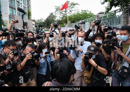 Members of the press take photographs of Bao Choy-yuk Ling, a freelance journalist as she arrives at the Fanling Magistrates' Court for the hearing.Bao Choy-yuk Ling, a freelance journalist who worked with Hong Kong's public broadcaster RTHK (Radio Television Hong Kong) on investigations into the July 21 Yuen Long mob attack, arrives wearing a facemask at Fanling Magistrates' Court for a hearing. Choy was arrested for making a false statement related to her investigation into suspected persons involved in the Yuen Long mob attack for a RTHK TV documentary. Stock Photo