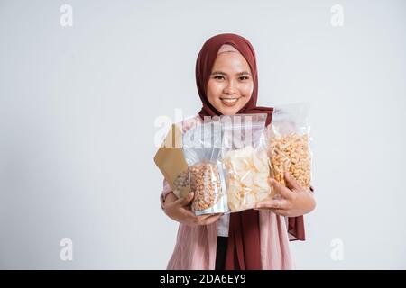 Happy business muslim woman portrait bring the snacks in small bag Stock Photo