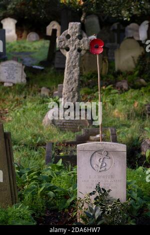 10 November 2020, Merton Park, London, UK. Single Remembrance poppy on a Commonwealth War Grave in St Mary’s Church. Stock Photo