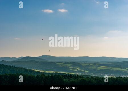 Two small hot air ballons over beautiful hilly landscape Stock Photo