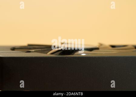 side view of video card with cooler on peach colored background Stock Photo