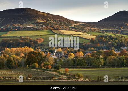 Melrose Abbey nestles in the foothills of The Eildon Hill amongst autumn foliage, as seen from Gattonside, Scottish Borders. Stock Photo