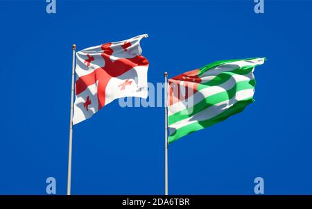 Beautiful national state flags of Georgia and Abkhazia together at the sky background. 3D artwork concept. Stock Photo