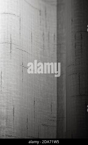 Light coming through a sheer cotton lace curtain. Abstract full frame background in black and white. Stock Photo