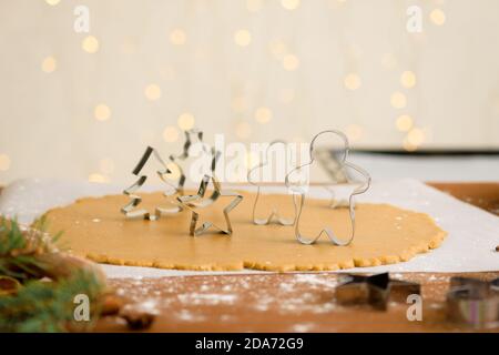 forms for gingerbread Christmas men and stars, close-up, top view, raw dough with cinnamon prepared for baking Stock Photo