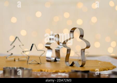 forms for gingerbread Christmas men and stars, close-up, top view, raw dough with cinnamon prepared for baking Stock Photo