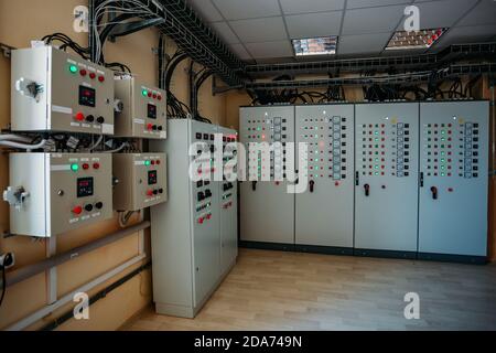 Electrical switchgear cabinets with control panels with indicator lights in factory Stock Photo