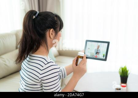Asian woman using video conference, make online consultation with doctor consulting about illness and medication via video call. Telehealth, Telemedic Stock Photo