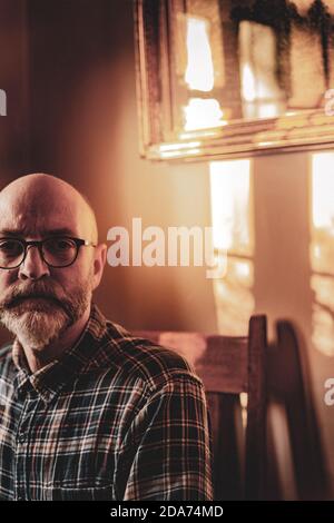 Sitting portrait of the photographer a middle aged male wearing spectacles with a beard Stock Photo