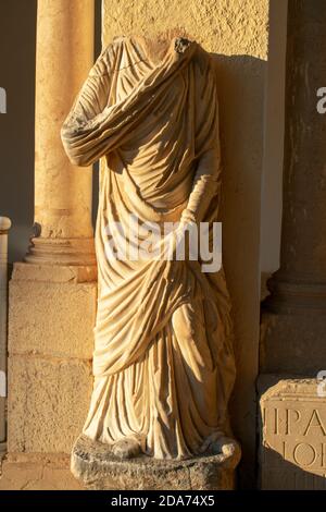 Vertical shot of a headless statue in the famous Roman ruins in Timgad, Algeria Stock Photo