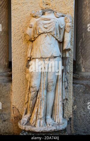 Vertical shot of a headless statue in the famous Roman ruins in Timgad, Algeria Stock Photo