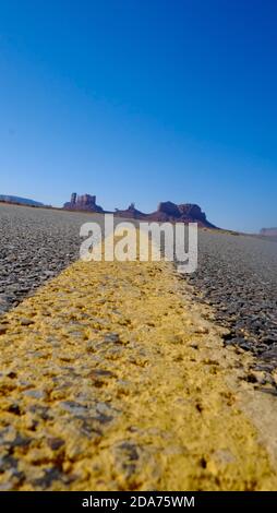 Worm's eye view of Highway 163 with yellow line, Utah Stock Photo