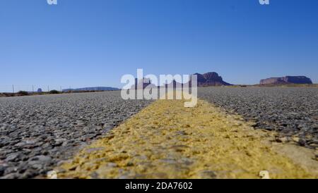 Worm's eye view of Highway 163 with yellow line, Utah Stock Photo