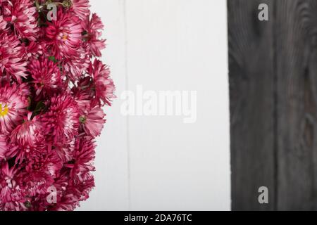 Bouquet of red chrysanthemums on a white table surface. Stock Photo