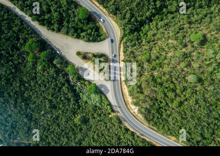 Aerial views of roads with curves in the middle of the forest Stock Photo