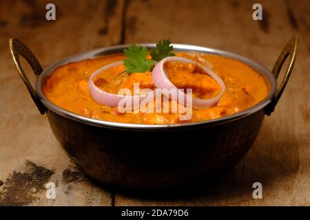Paneer Butter Masala or Cheese Cottage Curry, popular Indian Lunch/Dinner menu served in copper brass bowl Stock Photo