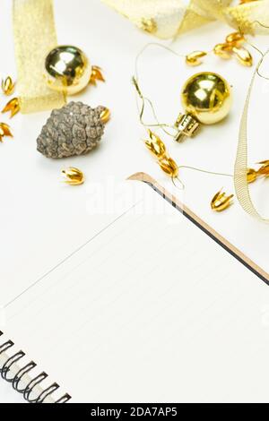 Blank notepad with Christmas decorations. Notepad for writing new resolutions for the new year. Planning the Xmas holidays. Copy space Stock Photo