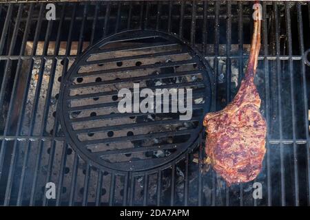 Dry Aged Barbecue Tomahawk Steak on grill Stock Photo