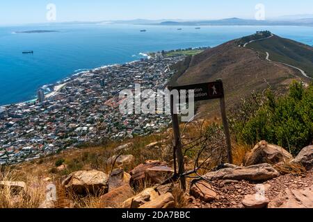Cape Town, South Africa - March 17, 2020: Wooden pole with hiker sign and words. Mountain Lion's Head Stock Photo