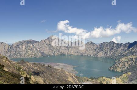 Mount Rinjani (or Gunung Rinjani) landscape at crater rim overlooking into crater lake and its volcanic mountain. Mountain Rinjani is an active volcan Stock Photo