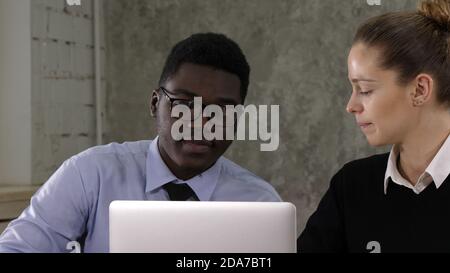 Two managers working on laptop Stock Photo