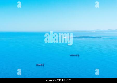 Cargo ships waiting in the middle of the sea to unload cargo Stock Photo