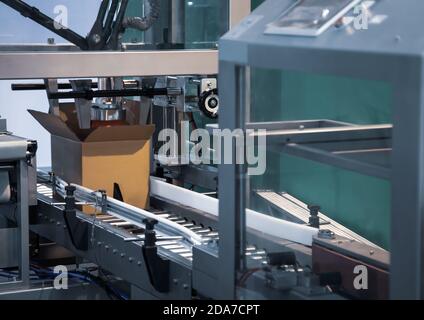 Process of carton forming machine in production line Stock Photo