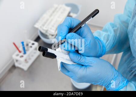 Scientist working with blood sample in laboratory Stock Photo