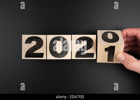 turning year 2020 to 2021 on wooden blocks, new year concept Stock Photo