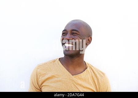 Close up portrait of smiling young african man against white background Stock Photo