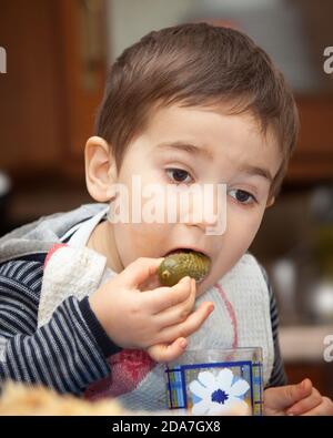 Little boy eats pickles Stock Photo