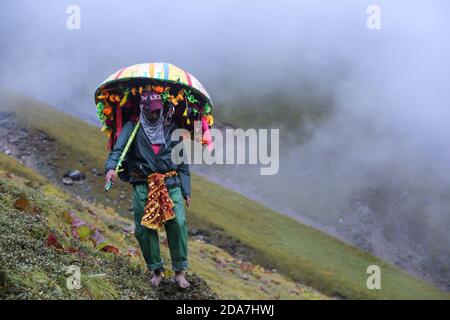 Chamoli, Uttarakhand, India, April 09 2014, Man on Nanda Devi Raj Jat religious yatra in India. The three-week-long Nanda Devi Raj Jaat is a pilgrimage and festival of Uttarakhand in India.  Stock Photo