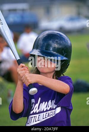 A Little League baseball game underway at a city park in Redmond, Oregon, during the summer. Stock Photo