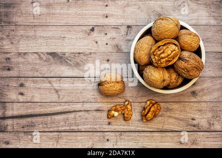 Bowl of walnuts with a wooden background, copy space and top view Stock Photo