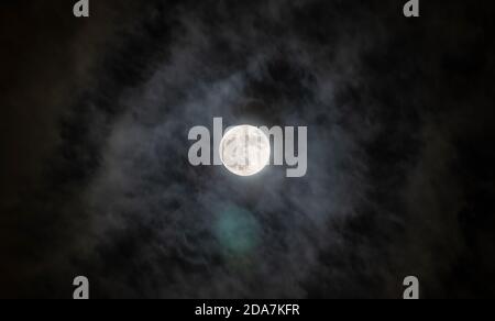 Full moon with fog and cloudy. The moon was not furnished. The night sky and a full moon in the clouds. Stock Photo