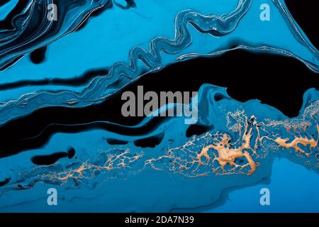 Acrylic Fluid Art. Blue waves and gold inclusion. Abstract stone background or texture Stock Photo