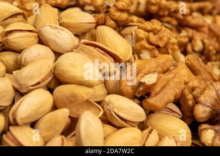 Pistachios and walnuts lie on the sacking. Close up Stock Photo