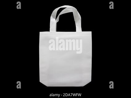White Mock-up Bag Isolated on Black Background. ECO Friendly Shopping Bags. Non Woven Fabric Bag. Copy Space for Text and Logo for your Advertisement Stock Photo