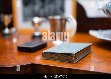 Small old book on a side table Stock Photo