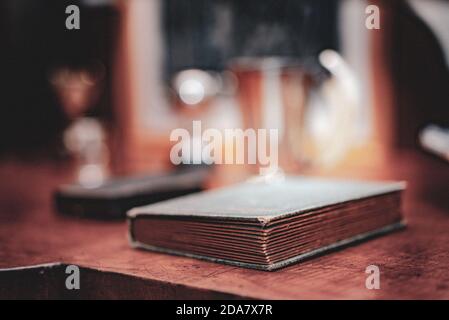 Small old book on a side table Stock Photo