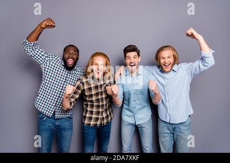 Portrait of four nice attractive glad ecstatic overjoyed cheerful cheery guys celebrating great attainment cup championship isolated over gray purple Stock Photo
