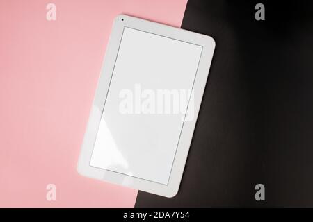 Tablet mock-up with white screen on pink and black Stock Photo
