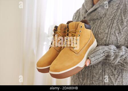 New mens leather brown waterproof winter autumn boots in hands Stock Photo