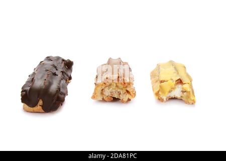 Closeup of two bitten and one whole delicious-looking Eclairs isolated on a white background Stock Photo